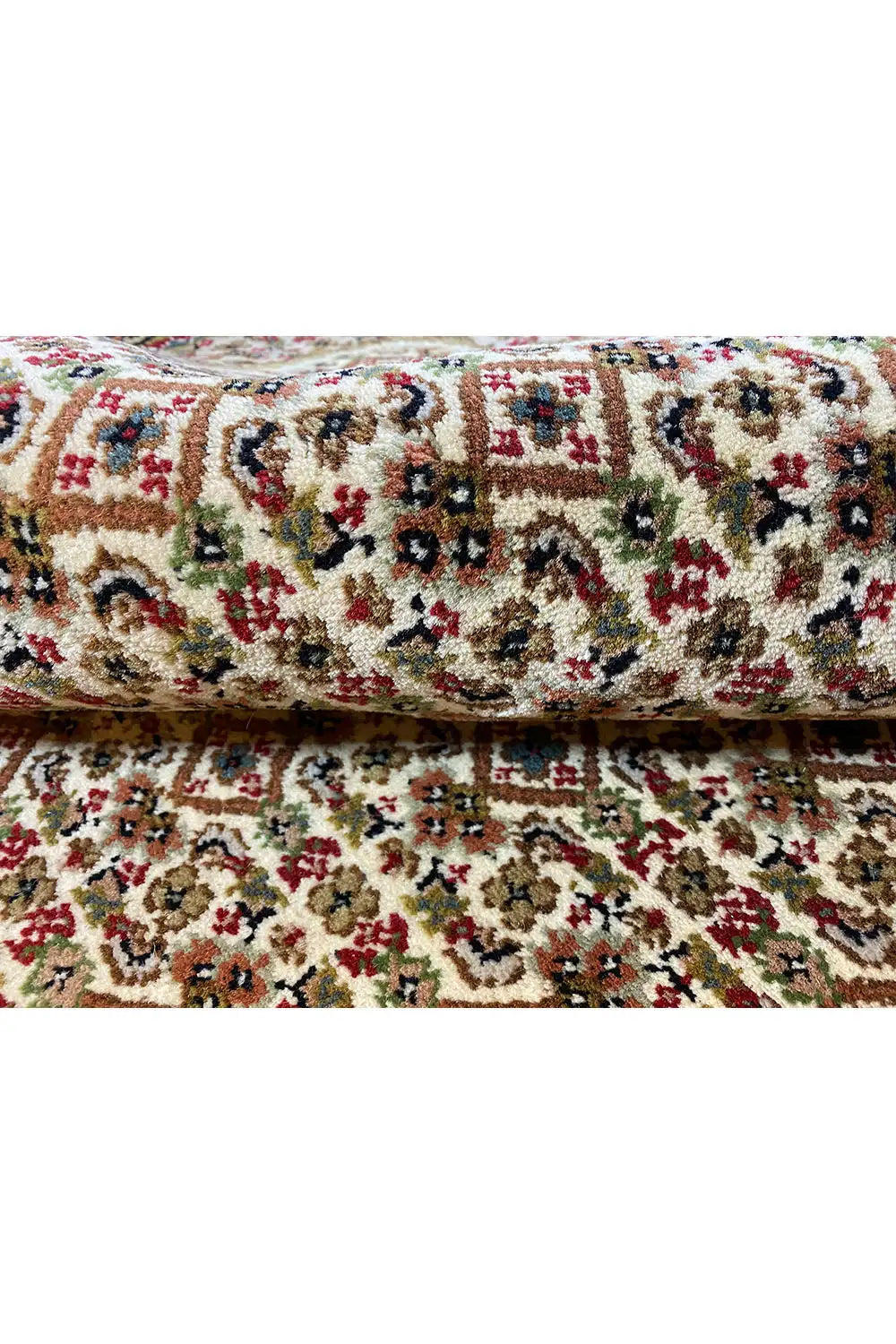 Rug with a multicolored tapestry pattern, curved edge, and dense pile structure