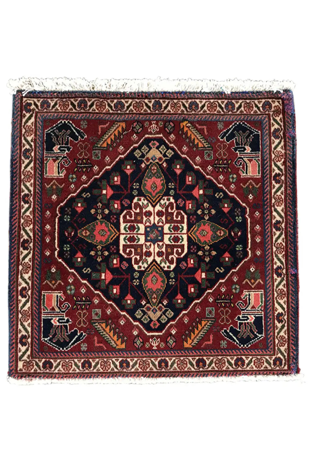 Square rug with a central medallion, dark background, colorful borders, and fringe