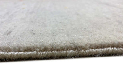 Gabbeh rug with bound pile and fringes along the edge, light beige color