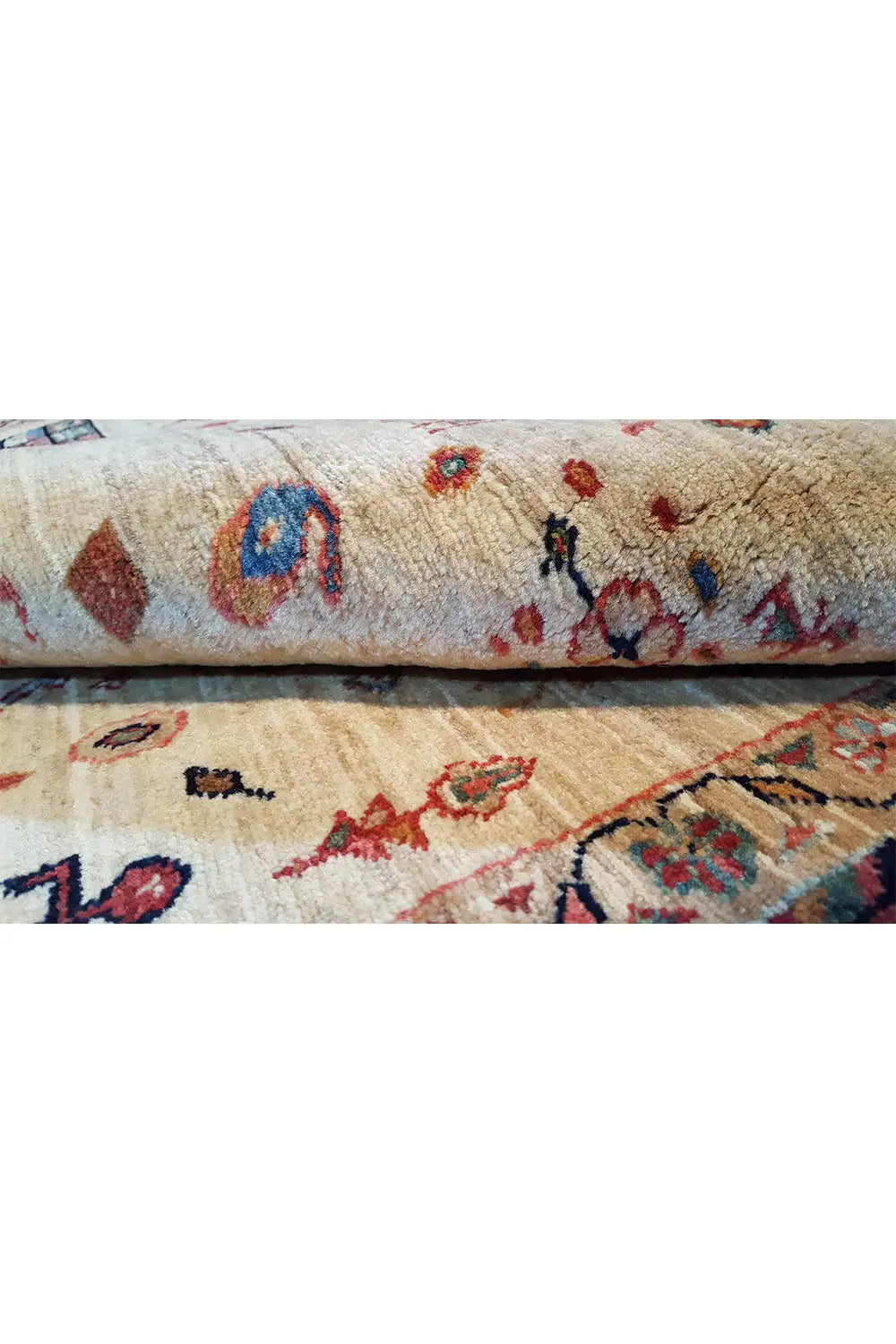 Oriental rug detail: beige pile with multicolored ornaments and borders