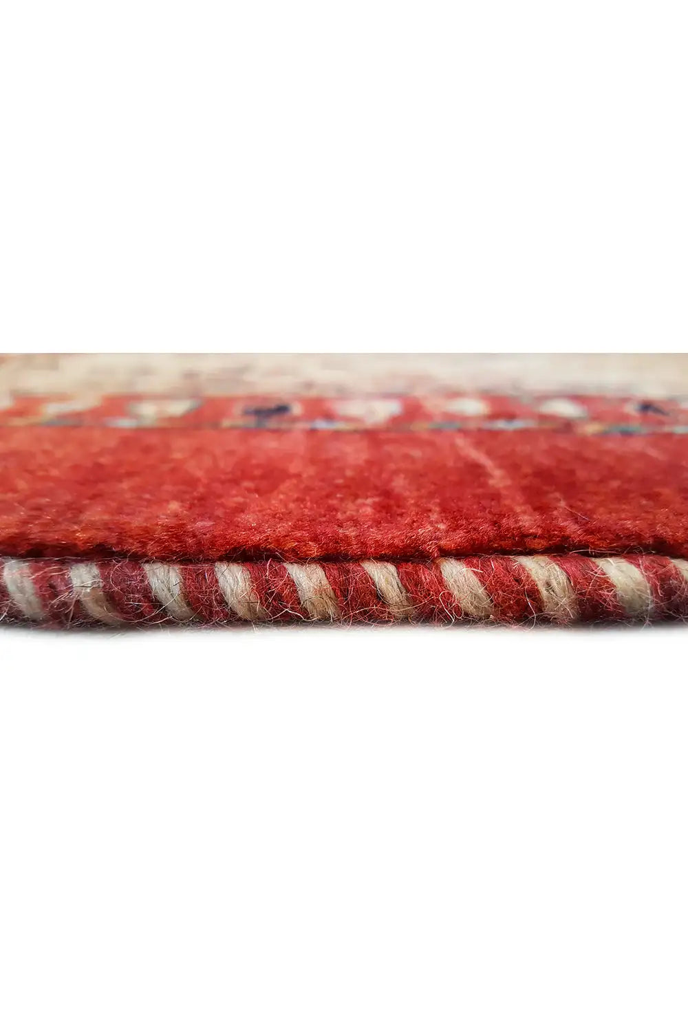 Carpet edge with red pile and braided border, multicolored