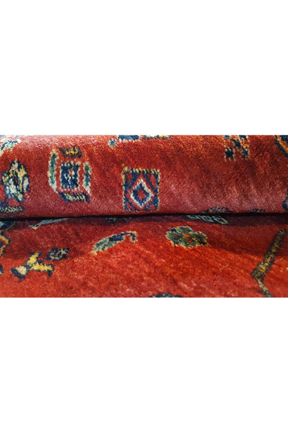 Close-up of carpet pile: red background with blue-green ornaments