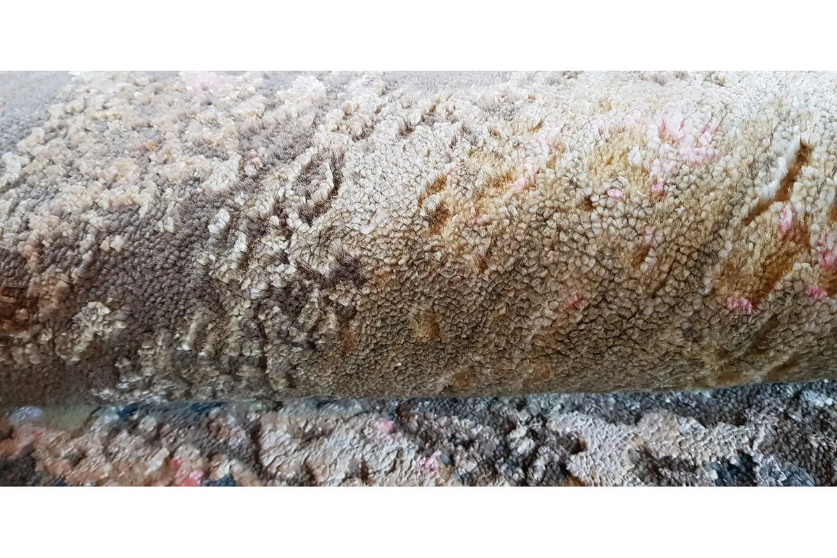 Rug with a dense pile and an abstract pattern in gray, beige, and blue with fine speckles