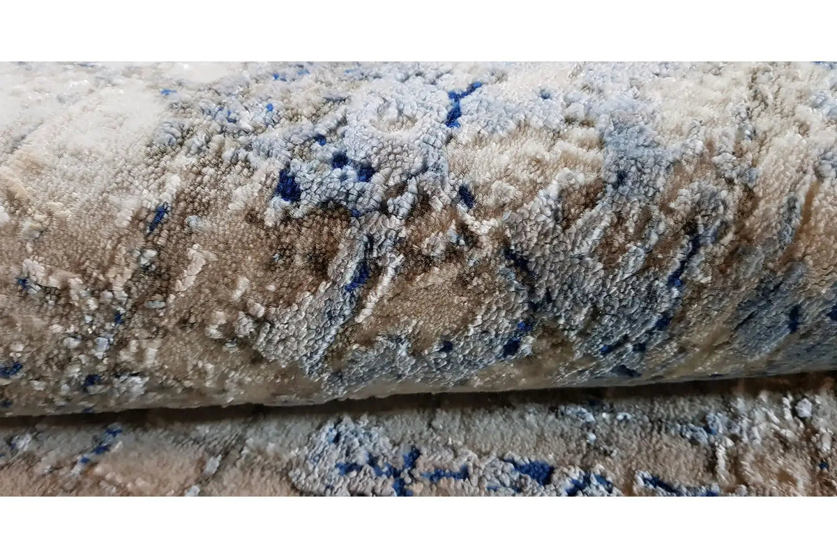 Rug with a light pile and blue color accents, abstract pattern (close-up)