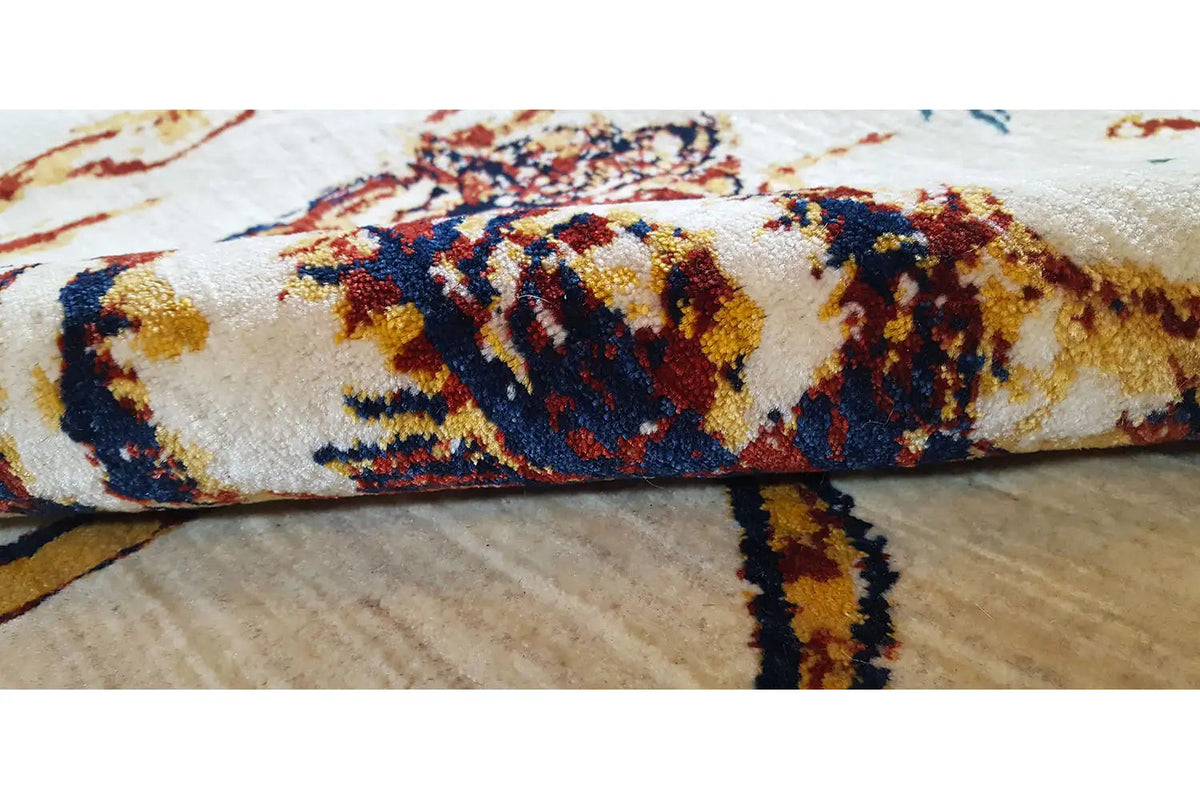 Carpet pile in detail with a dense, multicolored pattern along the edge