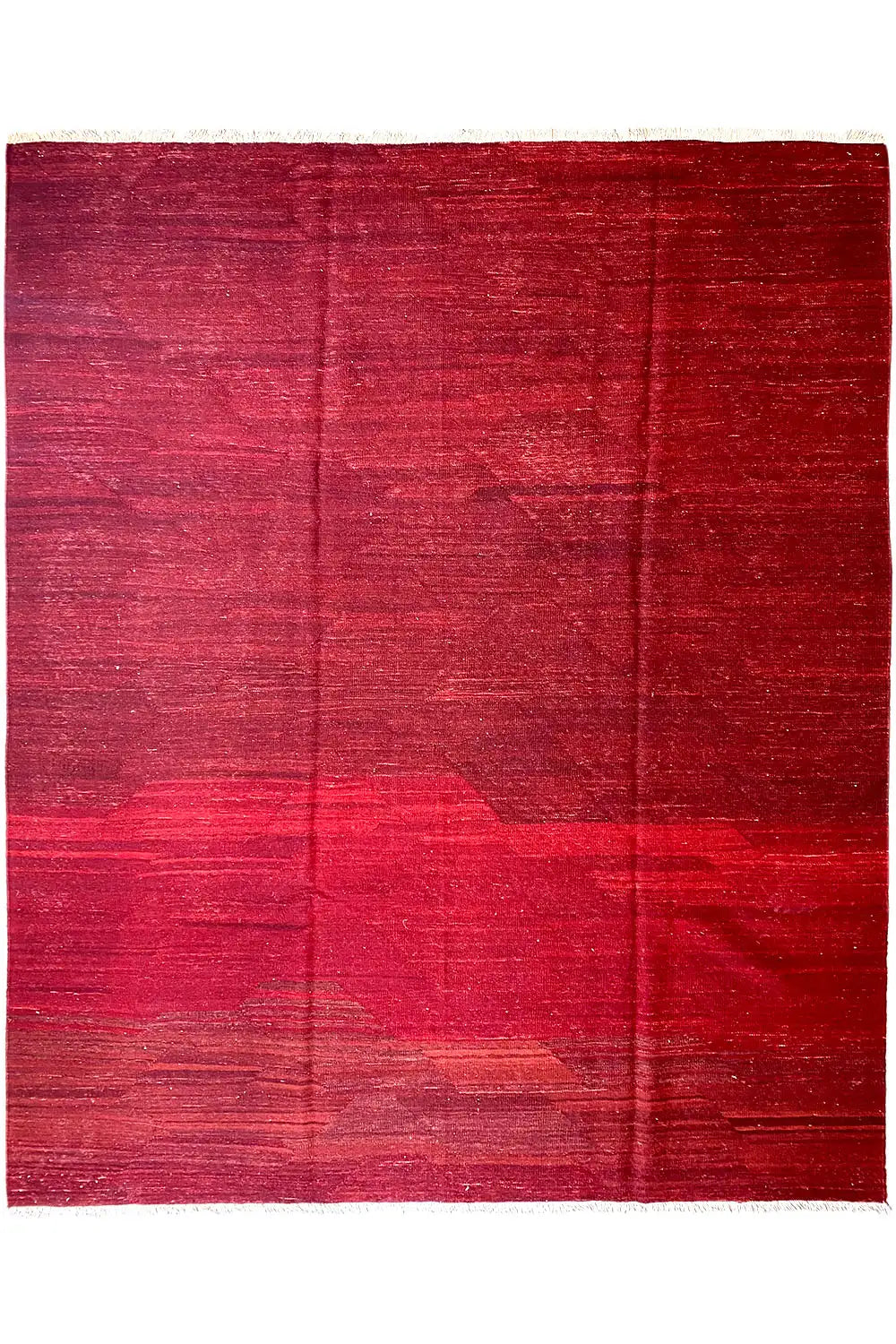 Red kilim rug with geometric color blocks and a fine woven texture, rectangular