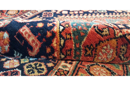 Oriental rug with a dark background and colorful medallion pattern, detailed border