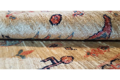 Rug with patterned motifs, beige pile, and colorful border details, close-up