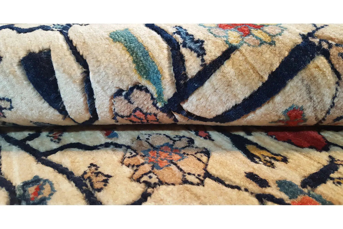 Carpet detail: beige vine motif with blue and red accents, woven border.