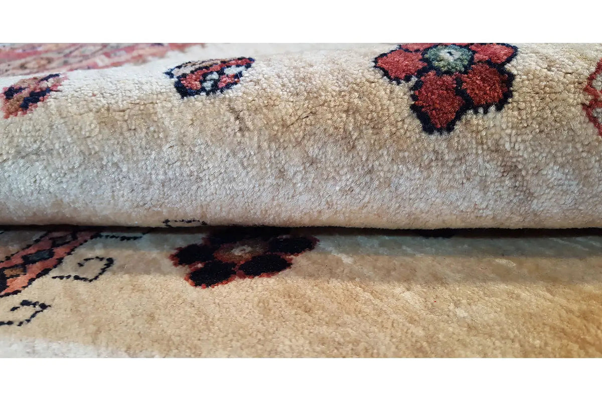 Beige carpet with dark red and blue-red floral patterns, close-up of the pile