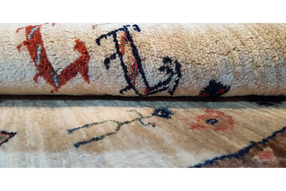 Carpet detail with a beige base and red/blue ornaments, dense pile.