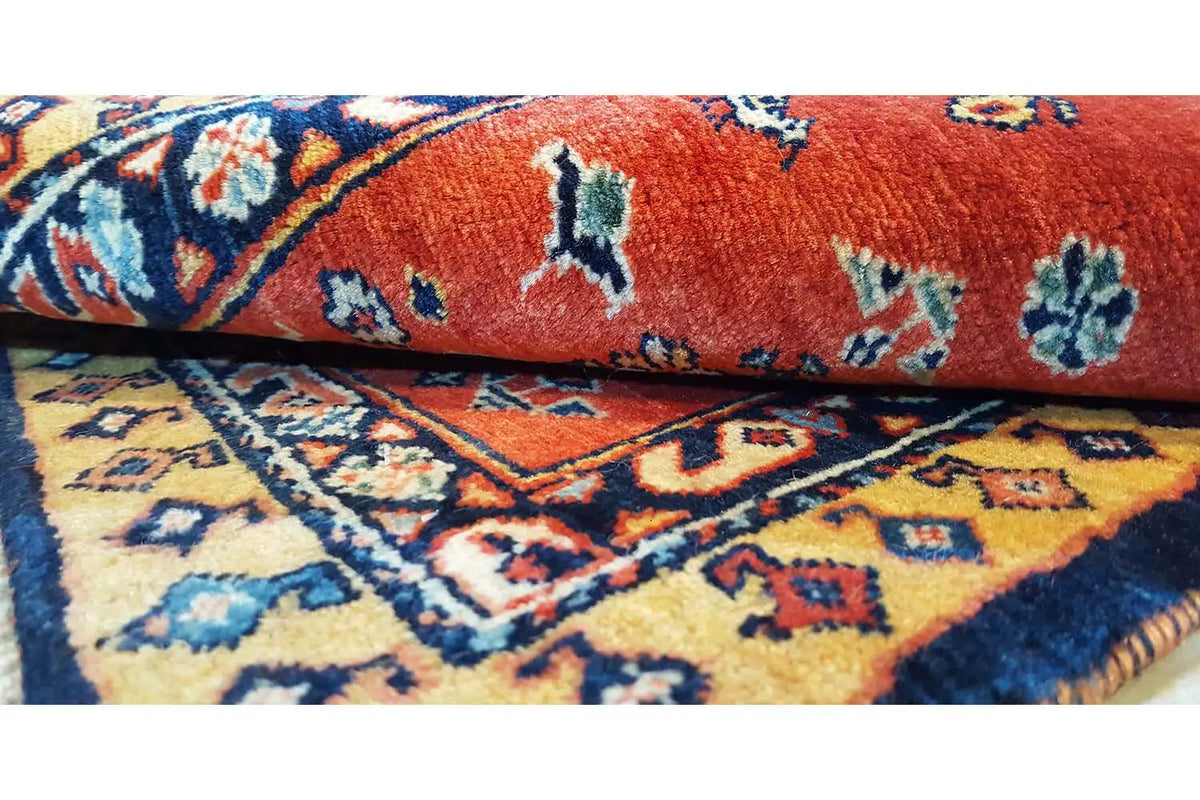 Oriental rug border with fringe, red background and blue-patterned edging