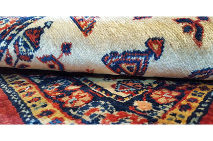 Small rug: cream-colored pile with blue and red ornaments and a border