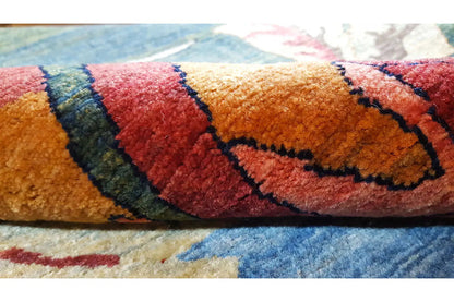 Carpet with a colorful pattern (red, orange, blue) - close-up of the border