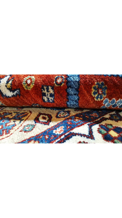 Oriental rug with a geometric pattern and a multicolored border, blue and red