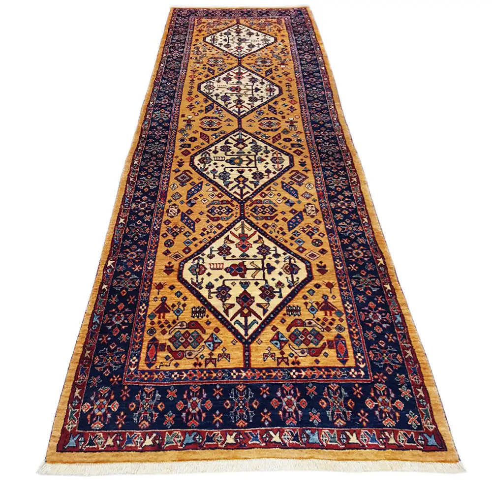 Runner rug with an ornamental pattern in gold, dark blue, and red, with bound edges