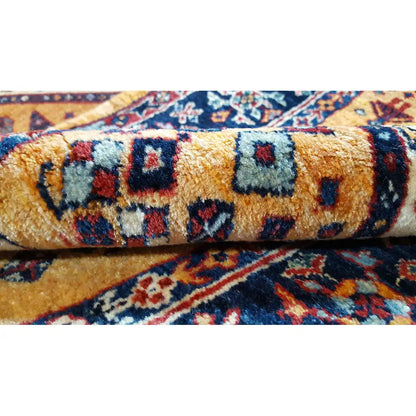 Runner rug detail with knotted pile and colorful ornamental motifs in blue, red, and gold