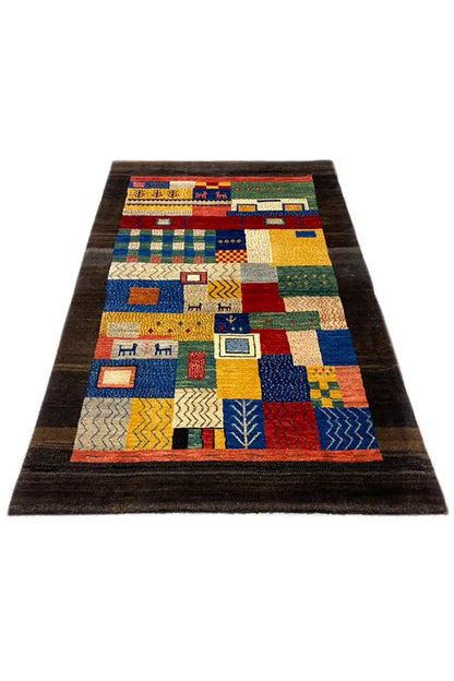 Long-format Gabbeh rug: dark border, multicolored patchwork with symbols
