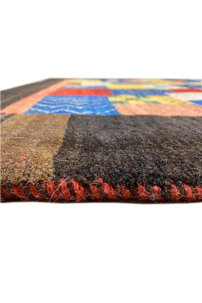 Close-up of the rug edge: dense pile, multicolored patterned area with relief