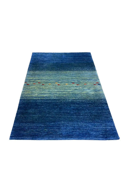 Blue carpet with a broad color gradient and horizontal stripes, colorful dots