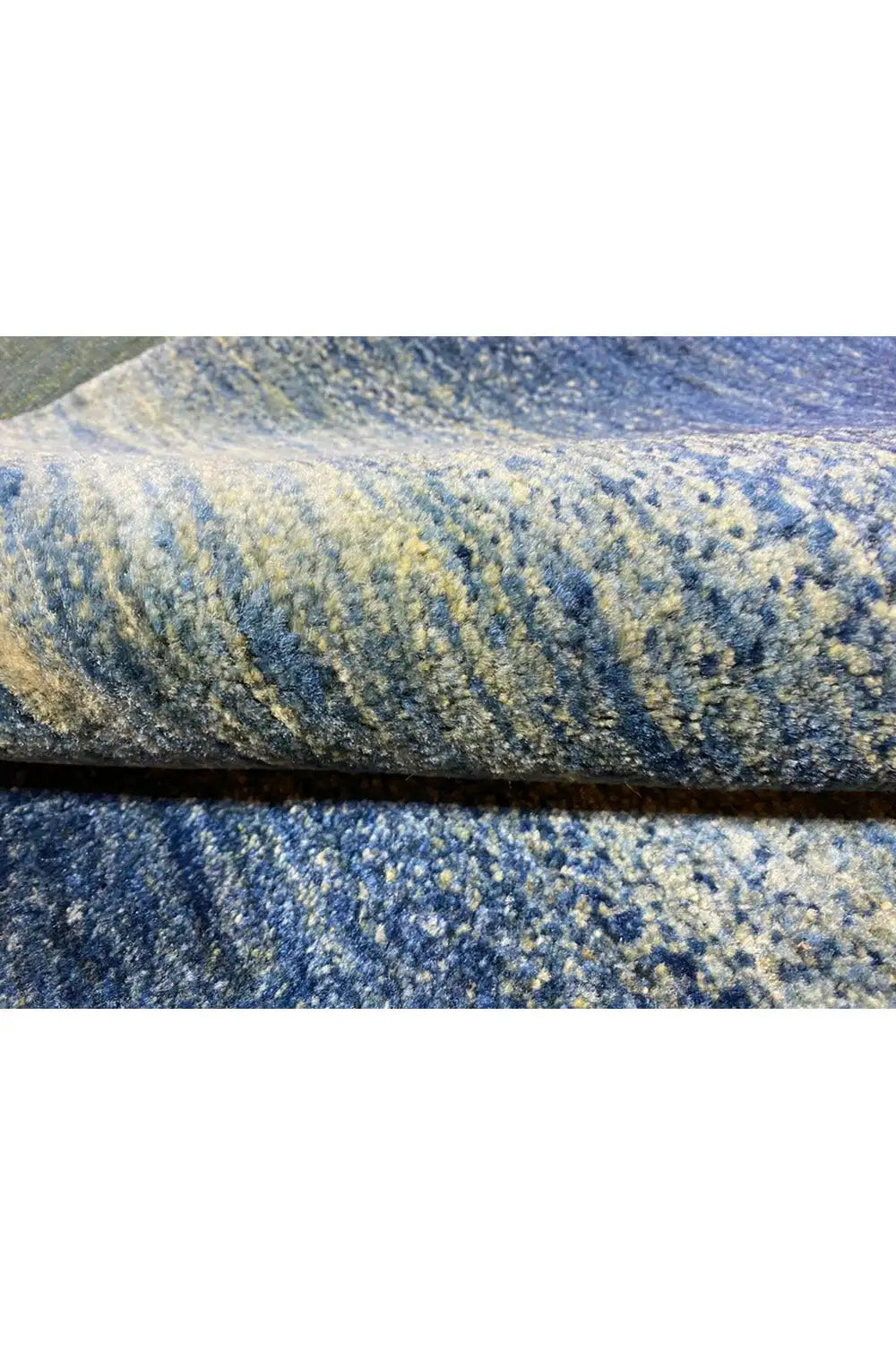 Carpet edge in detail: blue pile with a fine texture and subtle color transitions