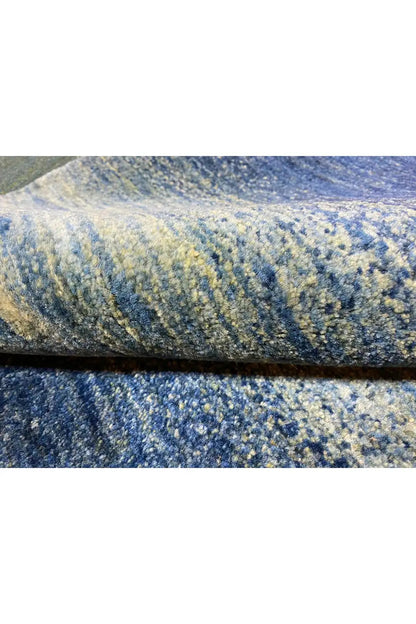 Carpet edge in detail: blue pile with a fine texture and subtle color transitions