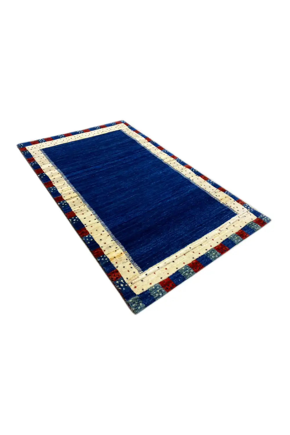 Gabbeh rug at an oblique angle: blue field, cream border, red-and-blue patterned edge