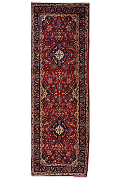 Red Oriental rug with a blue-framed medallion on an elongated field