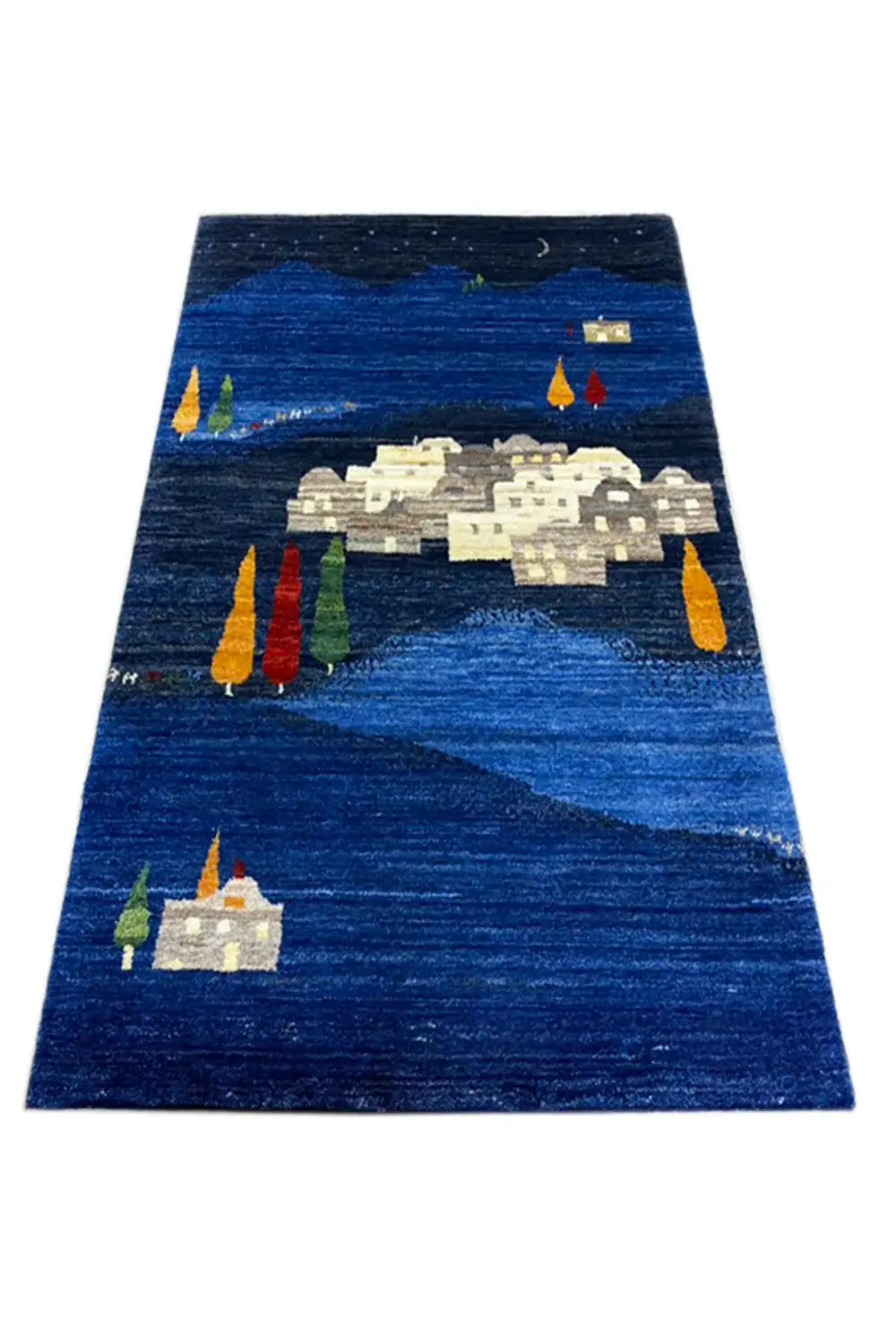 Gabbeh rug, blue background with a central house pattern and colorful candles/trees