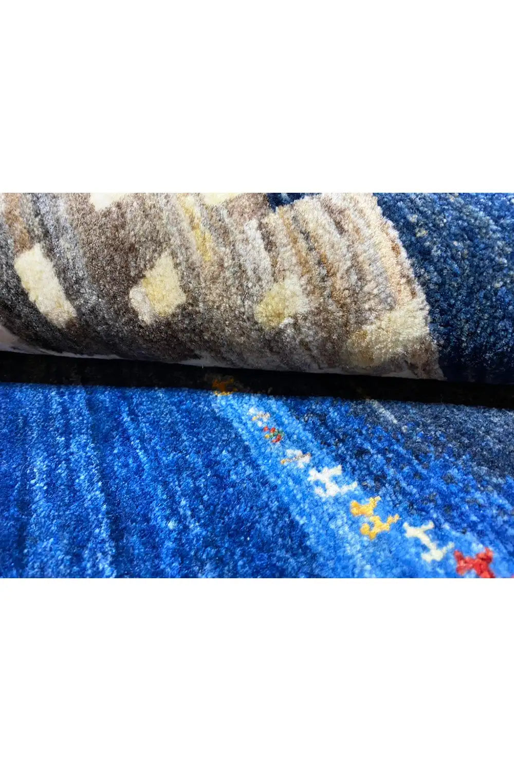 Gabbeh rug, close-up of the pile and edge with a beige pattern and blue background