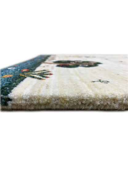 Carpet detail with pile and knotted border, light beige surface with dark blue edging