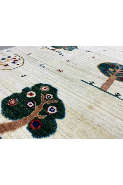 Carpet detail: tree and floral motif on a light beige background with a dark blue border