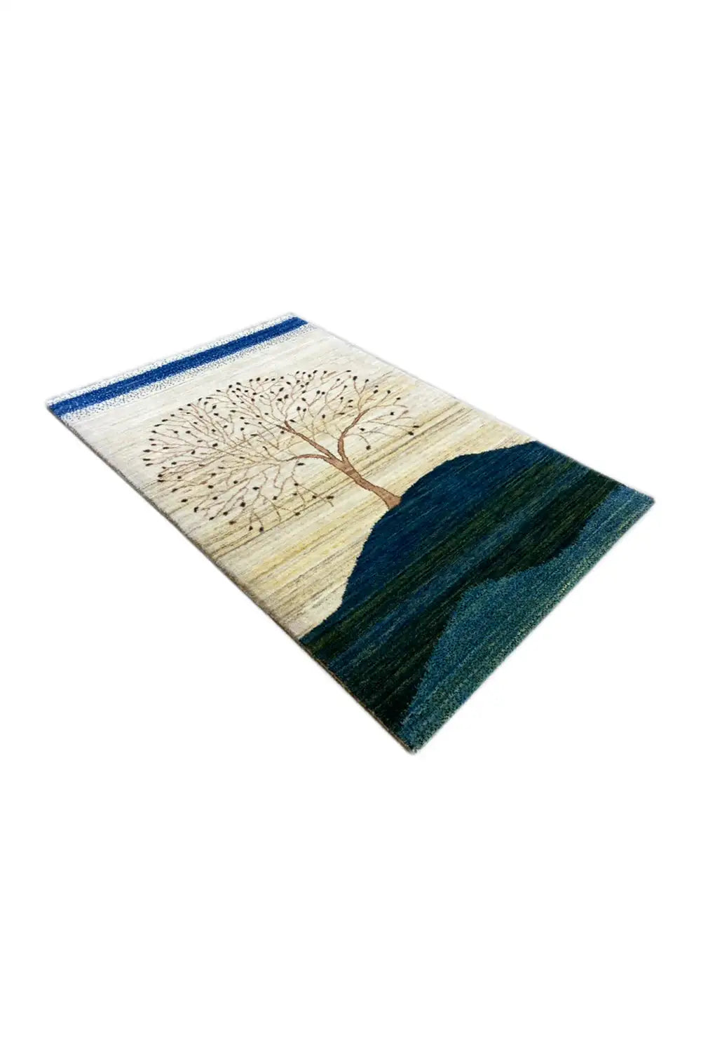 Gabbeh rug 122x78 cm viewed from an oblique angle: tree motif and blue landscape bands.