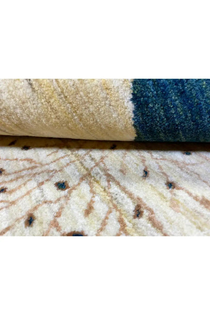 Gabbeh rug 122x78 cm Detail of the edge: pile with beige and blue areas.