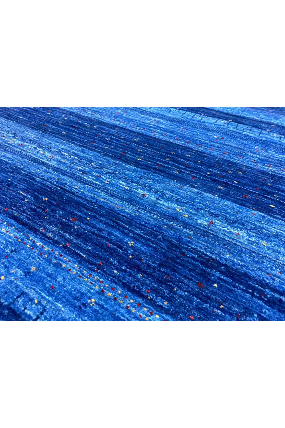 Blue carpet fabric with a fine texture and multicolored dots