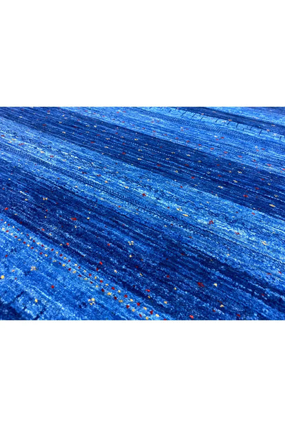 Blue carpet fabric with a fine texture and multicolored dots