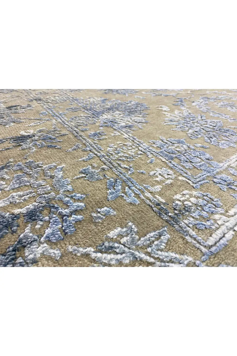 Designer rug in beige with a large-scale pattern and blue-gray lines, close-up