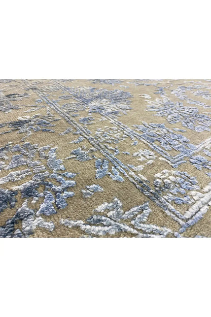 Designer rug in beige with a large-scale pattern and blue-gray lines, close-up