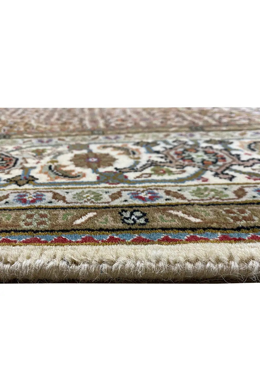 Carpet edge with fringe and multicolored border, detail of the patterned area