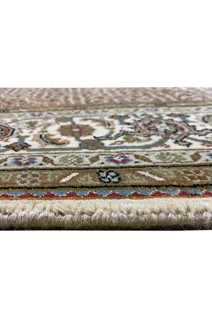 Carpet edge with fringe and multicolored border, detail of the patterned area