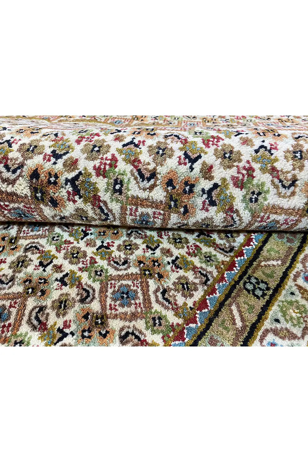 Close-up: carpet with a colorful floral pattern and dense texture, bordered edge
