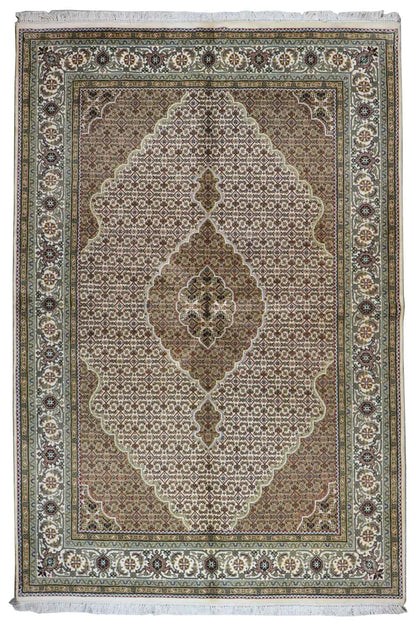 Oriental rug with a brown-beige medallion and floral ornament, green border
