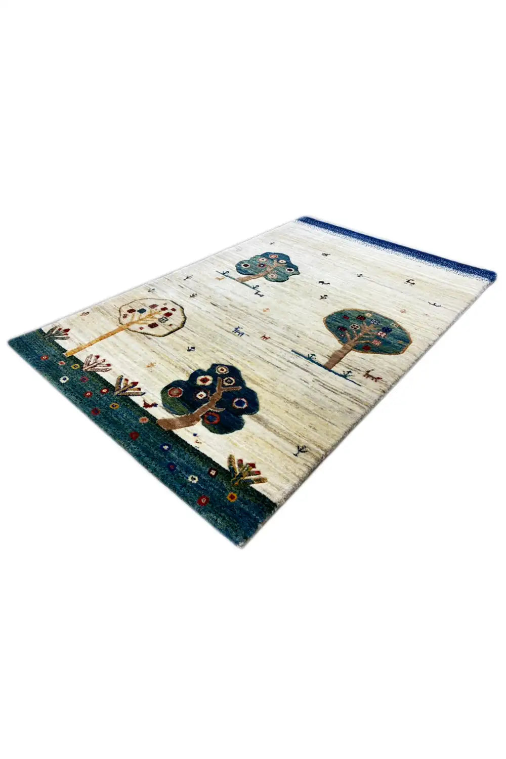 Gabbeh rug 119x75 cm, laid out at an angle, with tree and floral motifs in blue on beige