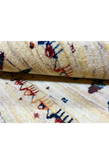 Gabbeh rug, pile detail: beige weave with red and blue patterns