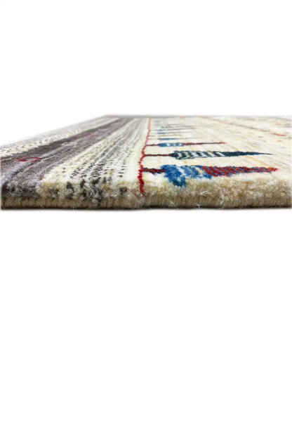 Gabbeh rug, edge detail: cream border and colored decorative stitching along the rug’s edge