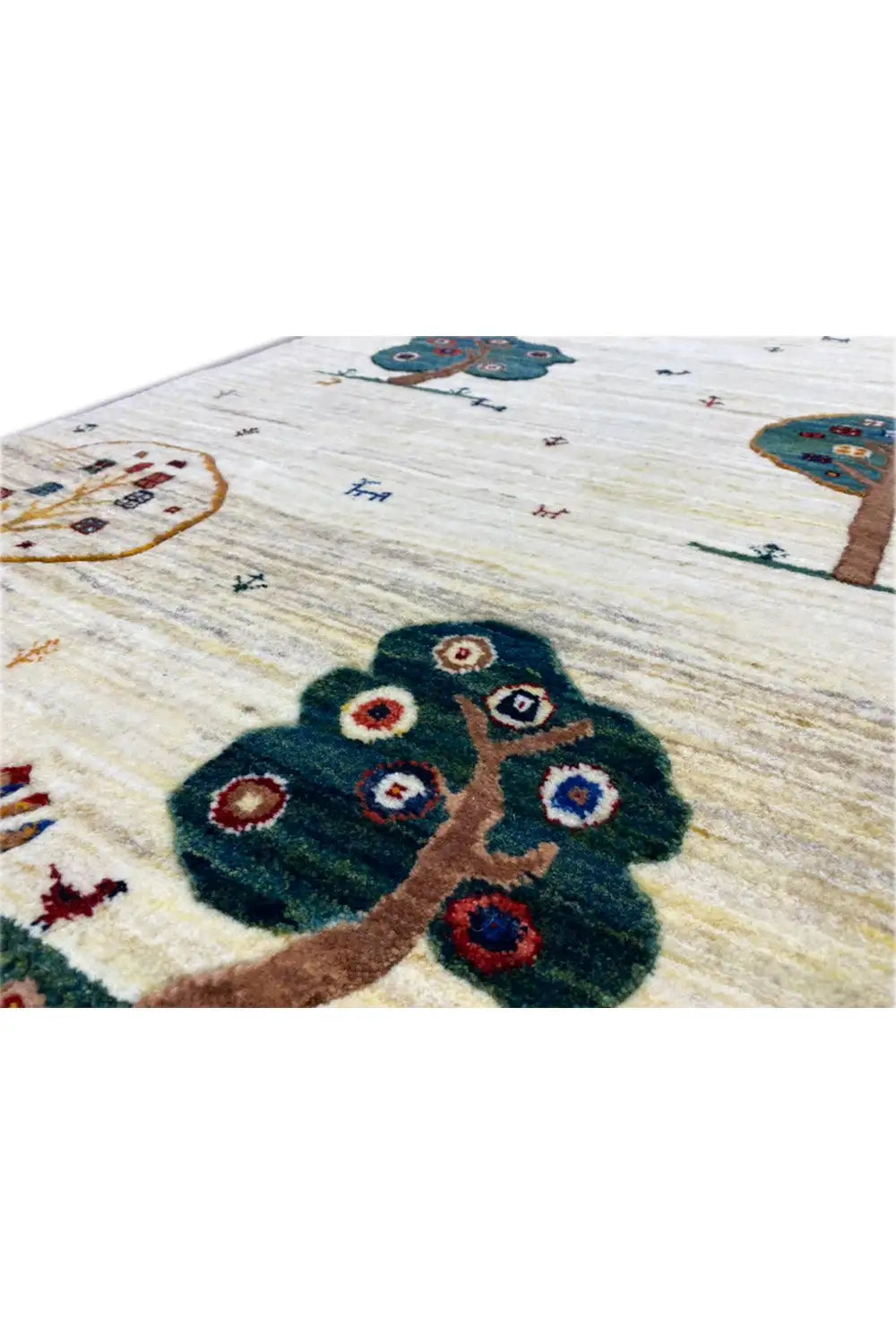 Gabbeh rug detail: dark tree appliqué motif on a cream-colored background