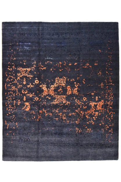 Dark blue rug with a large orange speckled pattern, square, flat-woven appearance