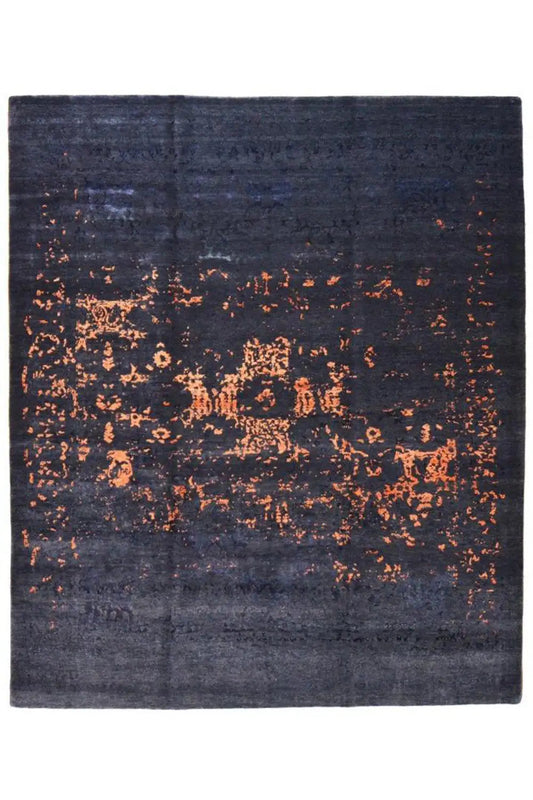Dark blue rug with a large orange speckled pattern, square, flat-woven appearance