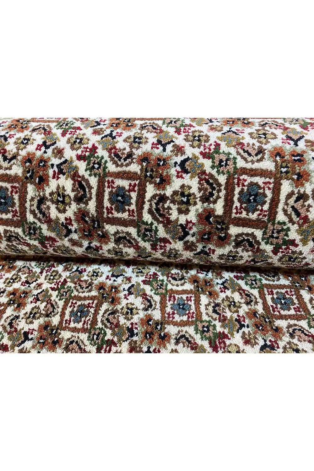 Carpet surface with a dense, multicolored ornamental pattern in red, green, and blue