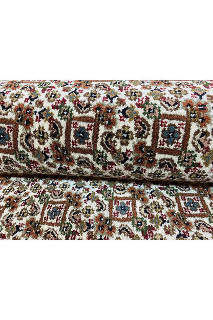 Carpet surface with a dense, multicolored ornamental pattern in red, green, and blue